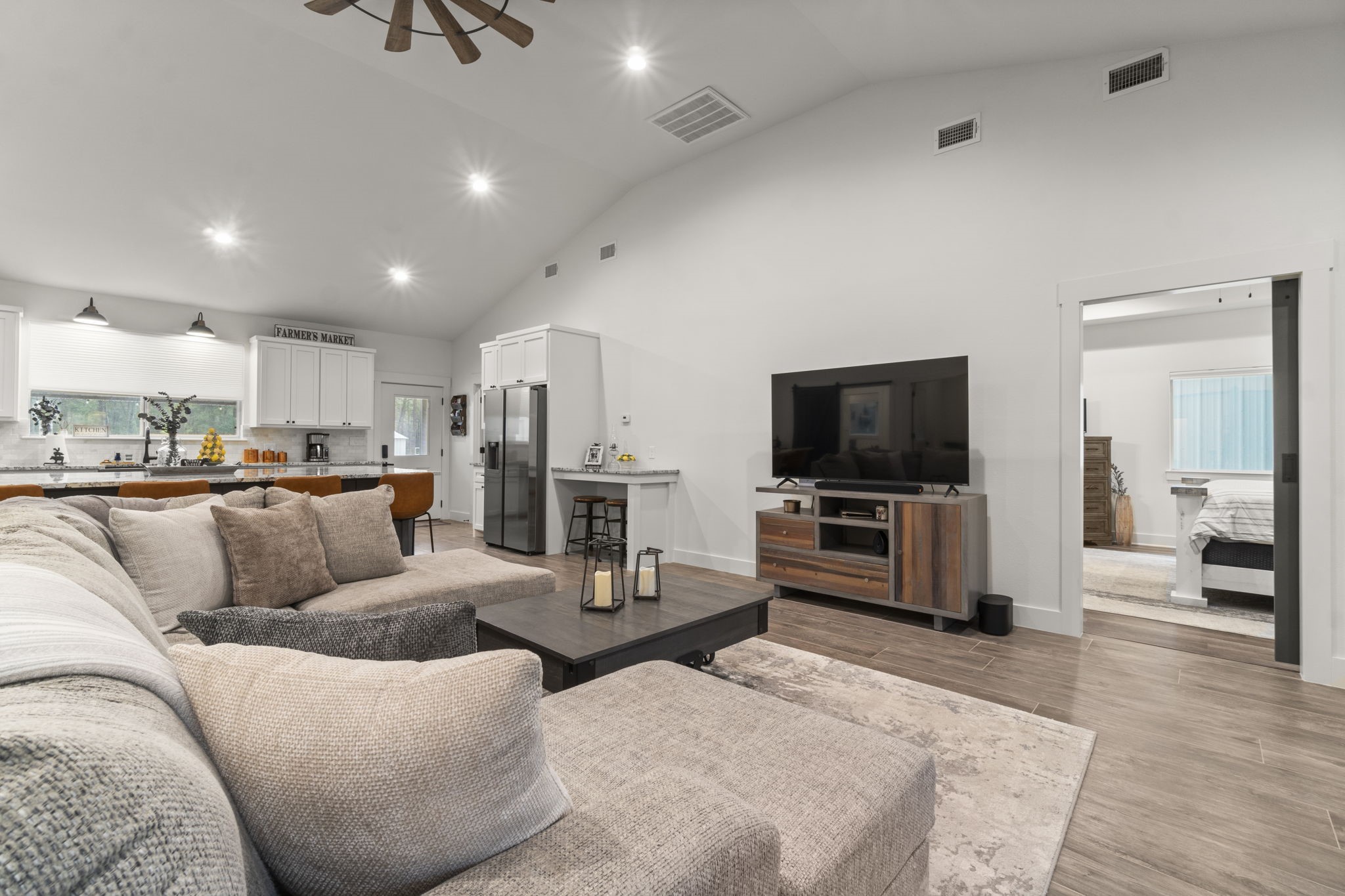 15651 Ben Wiggins Road Conroe, TX 77303 - Photo 6 of 47 a living room with furniture and a flat screen tv