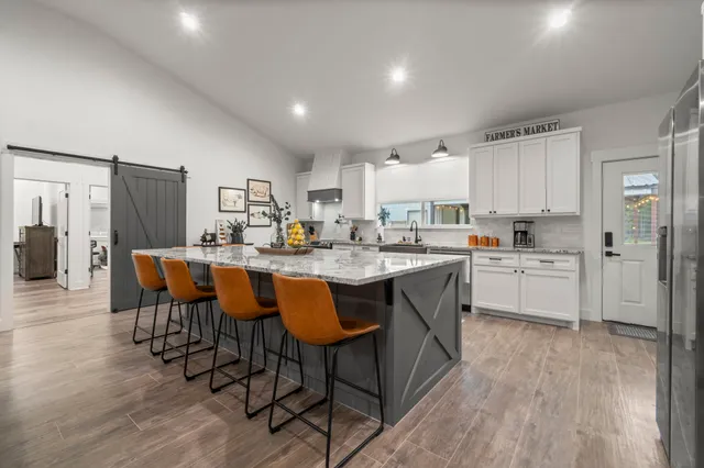 a kitchen with a sink cabinets and wooden floor