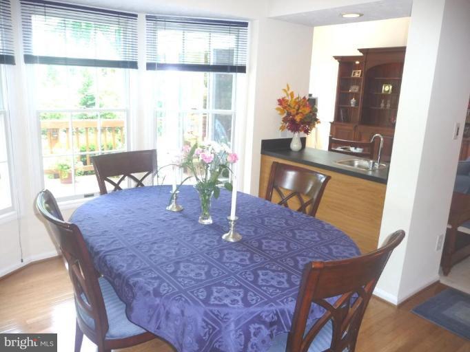 2325 Club Pond Lane Reston, VA 20191 - Photo 3 of 22 a view of a dining room with furniture and wooden floor
