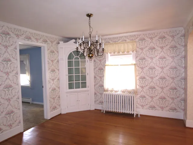 a view of a hallway with wooden floor and stairs