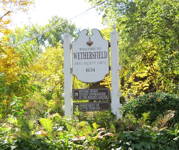 a sign broad in front of flowers