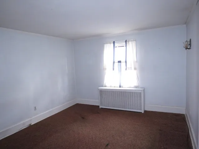 a view of an empty room with a ceiling fan