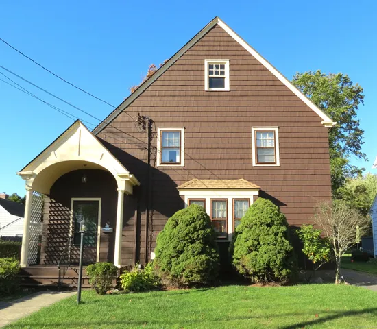 a front view of a house with garden