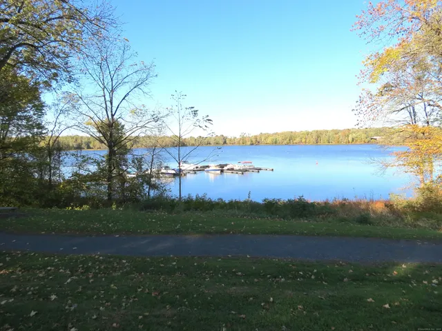 a view of a house with swimming pool and sitting area