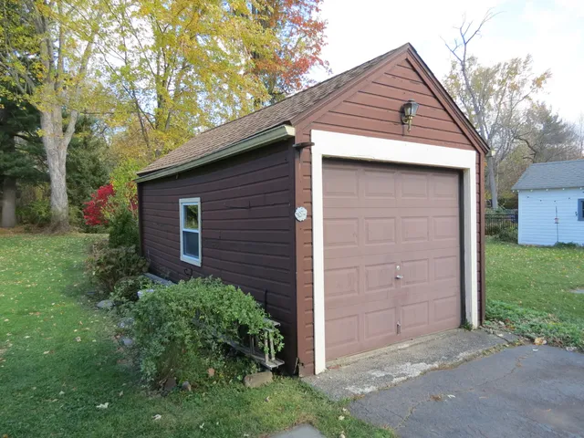 a front view of a house with a yard and trees