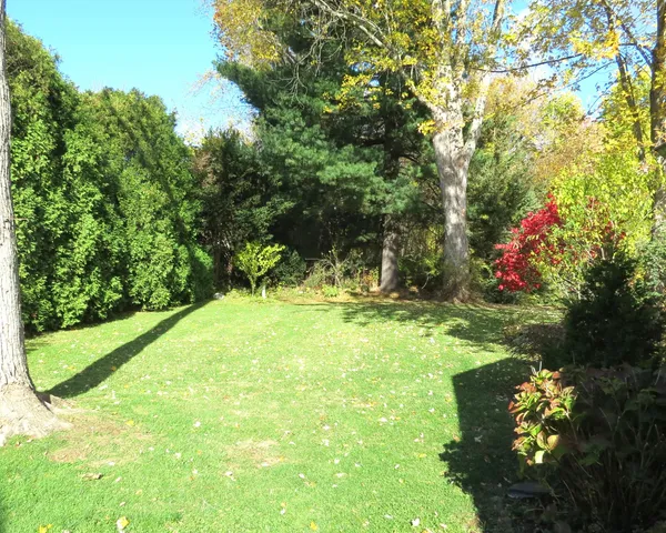 a kitchen with stainless steel appliances granite countertop a refrigerator a sink dishwasher and wooden cabinets with a dishwasher