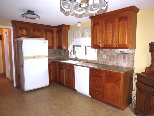 a kitchen that has a stove and a wooden floor