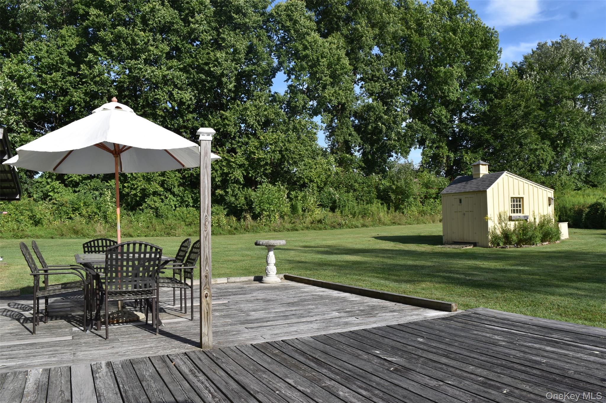 188 S Road Tivoli, NY 12583 - Photo 13 of 16 a view of a deck with a table and chairs under an umbrella