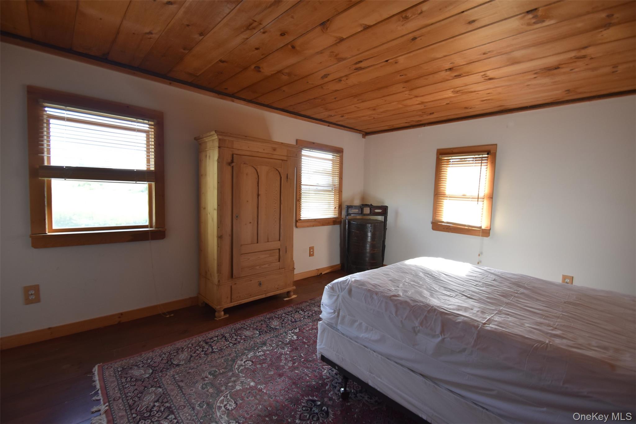 188 S Road Tivoli, NY 12583 - Photo 10 of 16 a spacious bedroom with a bed and a dresser next to a window