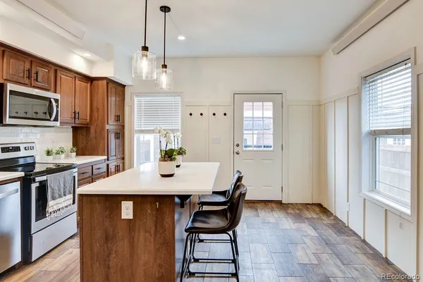 a kitchen with stainless steel appliances granite countertop a stove refrigerator sink microwave and cabinets