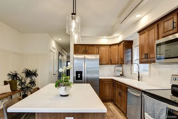 a kitchen with refrigerator a sink and cabinets