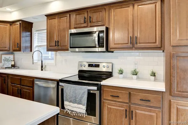 a kitchen with a sink stove and microwave