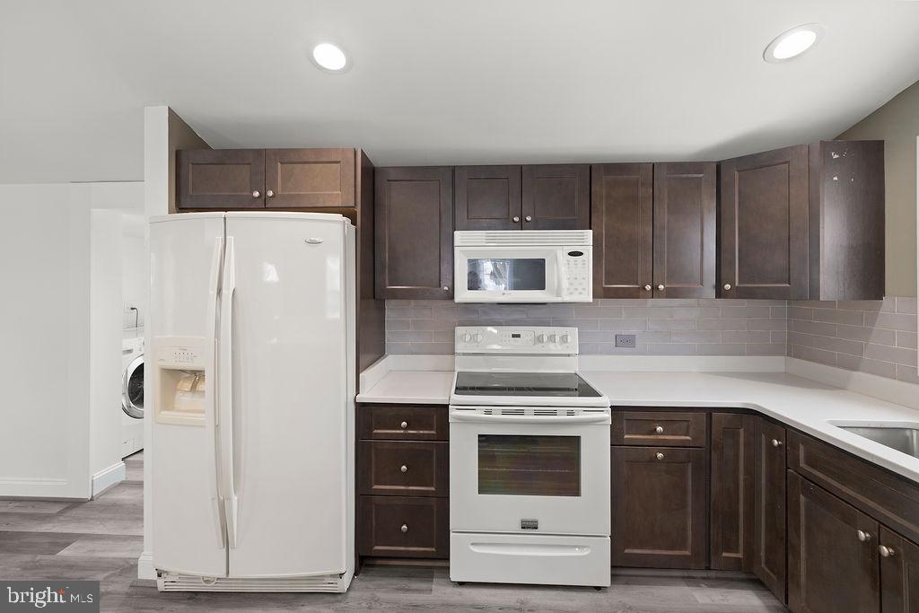 1806 Filbert Street York, PA 17404 - Photo 14 of 33 a kitchen with a white stove top oven and cabinets