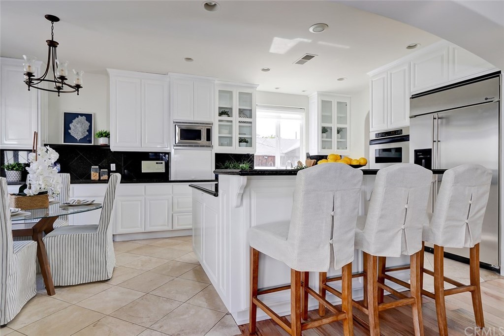 2818 North Ardmore Avenue Manhattan Beach, CA 90266 - Photo 12 of 34 a kitchen with stainless steel appliances kitchen island granite countertop a table and chairs in it