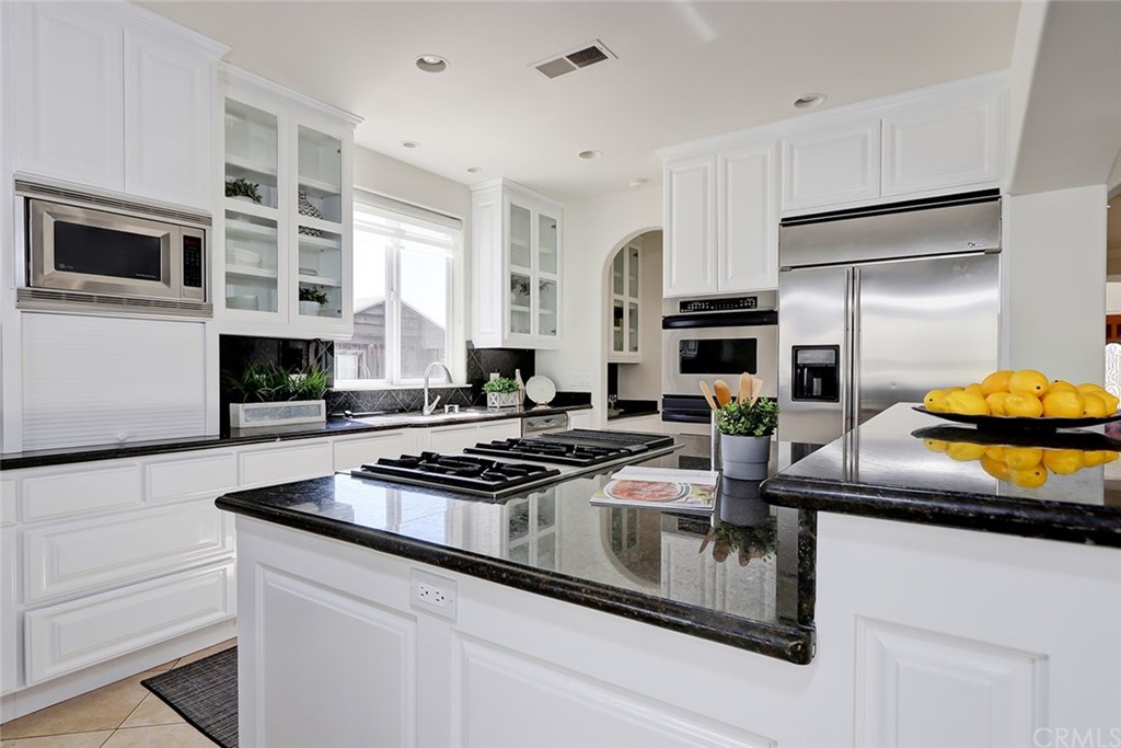 2818 North Ardmore Avenue Manhattan Beach, CA 90266 - Photo 13 of 34 a kitchen with stainless steel appliances granite countertop a stove a sink and a refrigerator