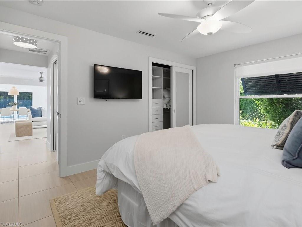 1390 Mandarin Road Naples, FL 34102 - Photo 39 of 50 Tile flooring, built-in closet organization, contemporary ceiling fan, and large window