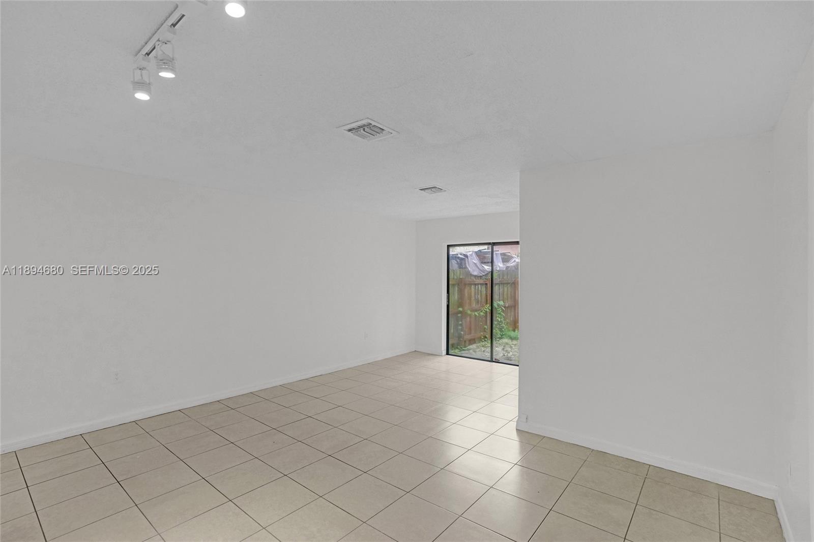 3876 Northwest 207 St Road Miami Gardens, FL 33055 - Photo 11 of 37 an empty room with windows
