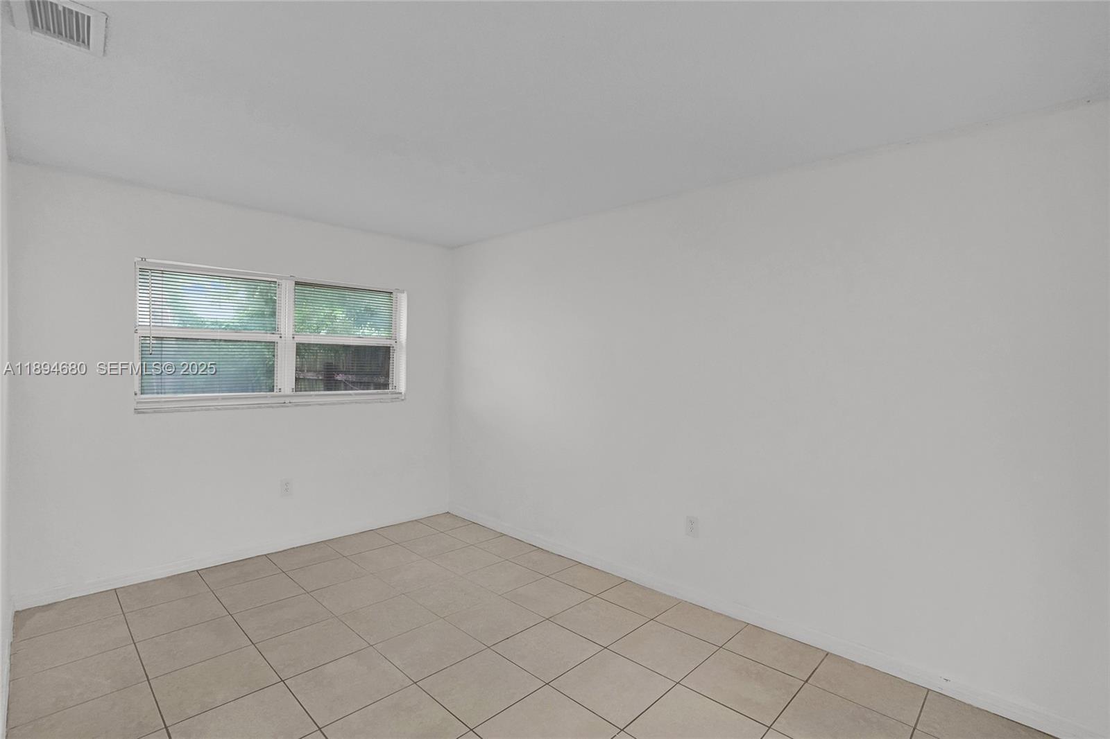 3876 Northwest 207 St Road Miami Gardens, FL 33055 - Photo 14 of 37 an empty room with windows