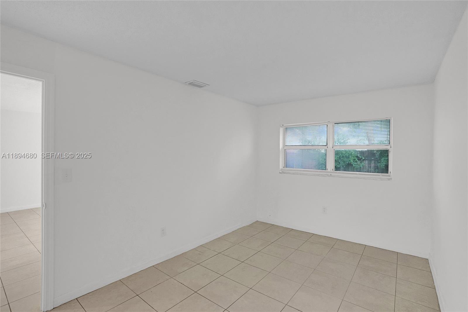 3876 Northwest 207 St Road Miami Gardens, FL 33055 - Photo 15 of 37 a view of an empty room with window