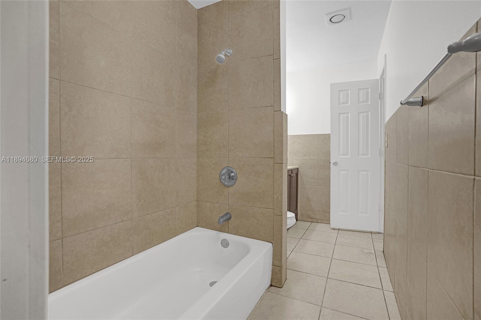 3876 Northwest 207 St Road Miami Gardens, FL 33055 - Photo 19 of 37 a bathroom with a bathtub and a shower