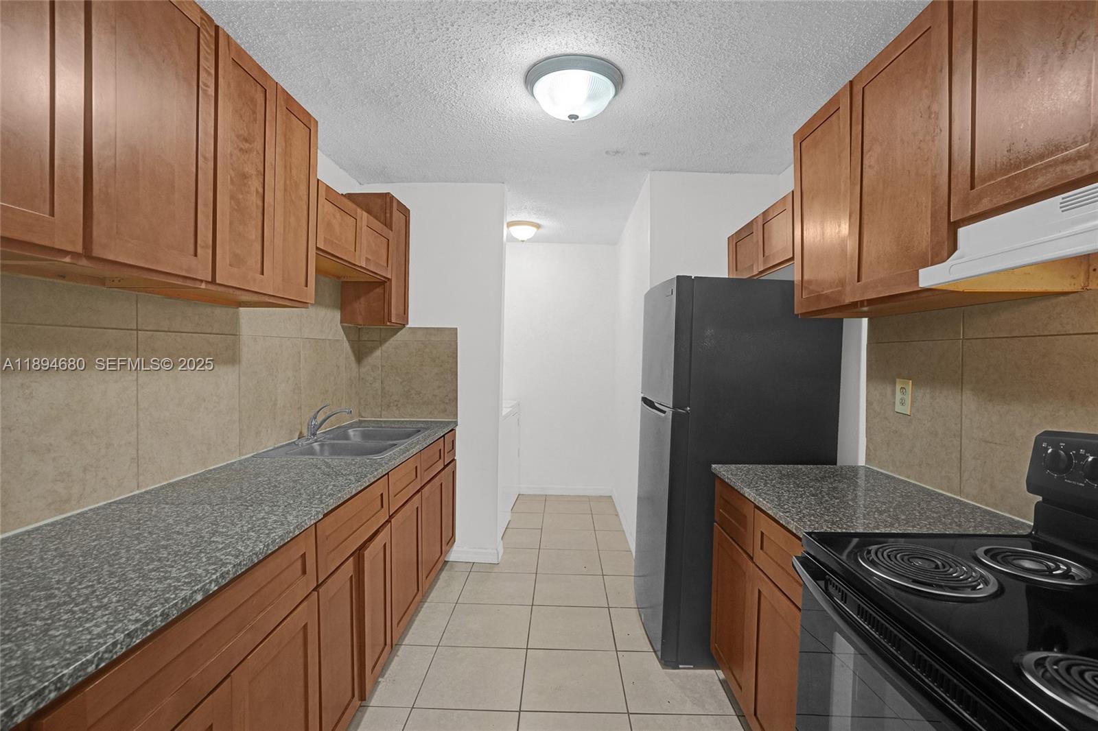 3876 Northwest 207 St Road Miami Gardens, FL 33055 - Photo 2 of 37 a kitchen with granite countertop cabinets and steel stainless steel appliances