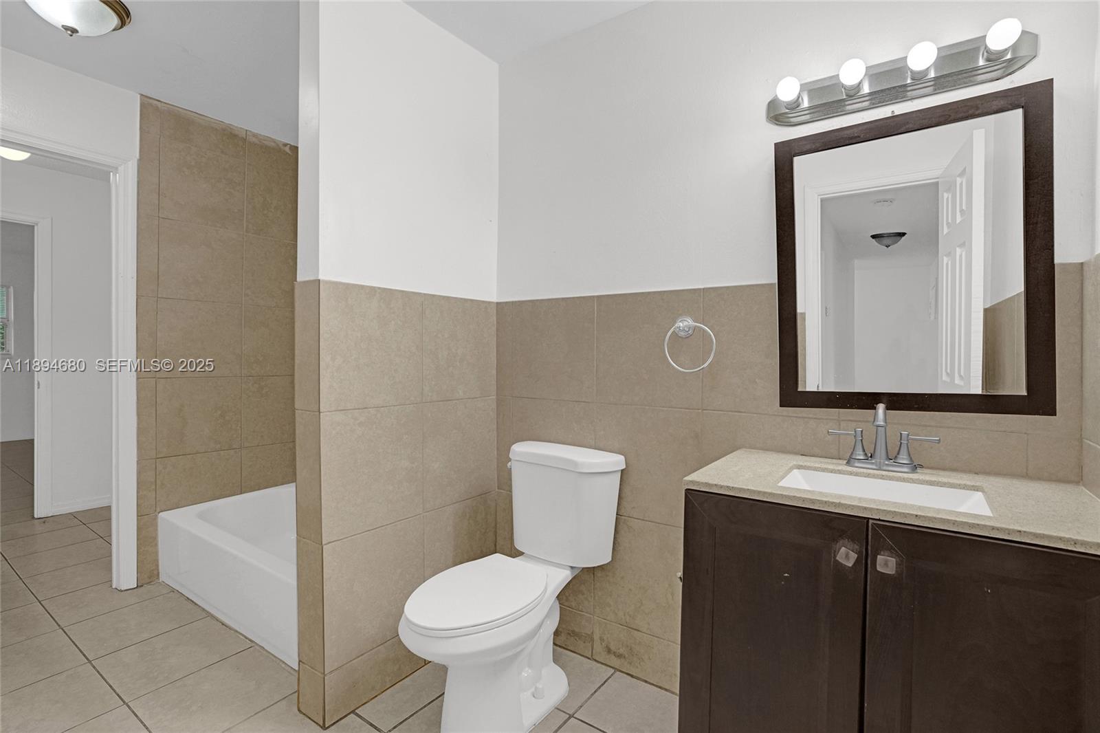 3876 Northwest 207 St Road Miami Gardens, FL 33055 - Photo 21 of 37 a bathroom with a sink a toilet and shower