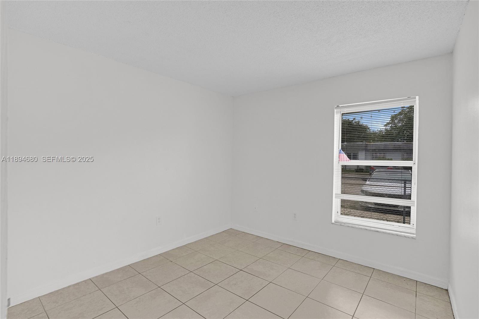 3876 Northwest 207 St Road Miami Gardens, FL 33055 - Photo 22 of 37 a view of an empty room with a window