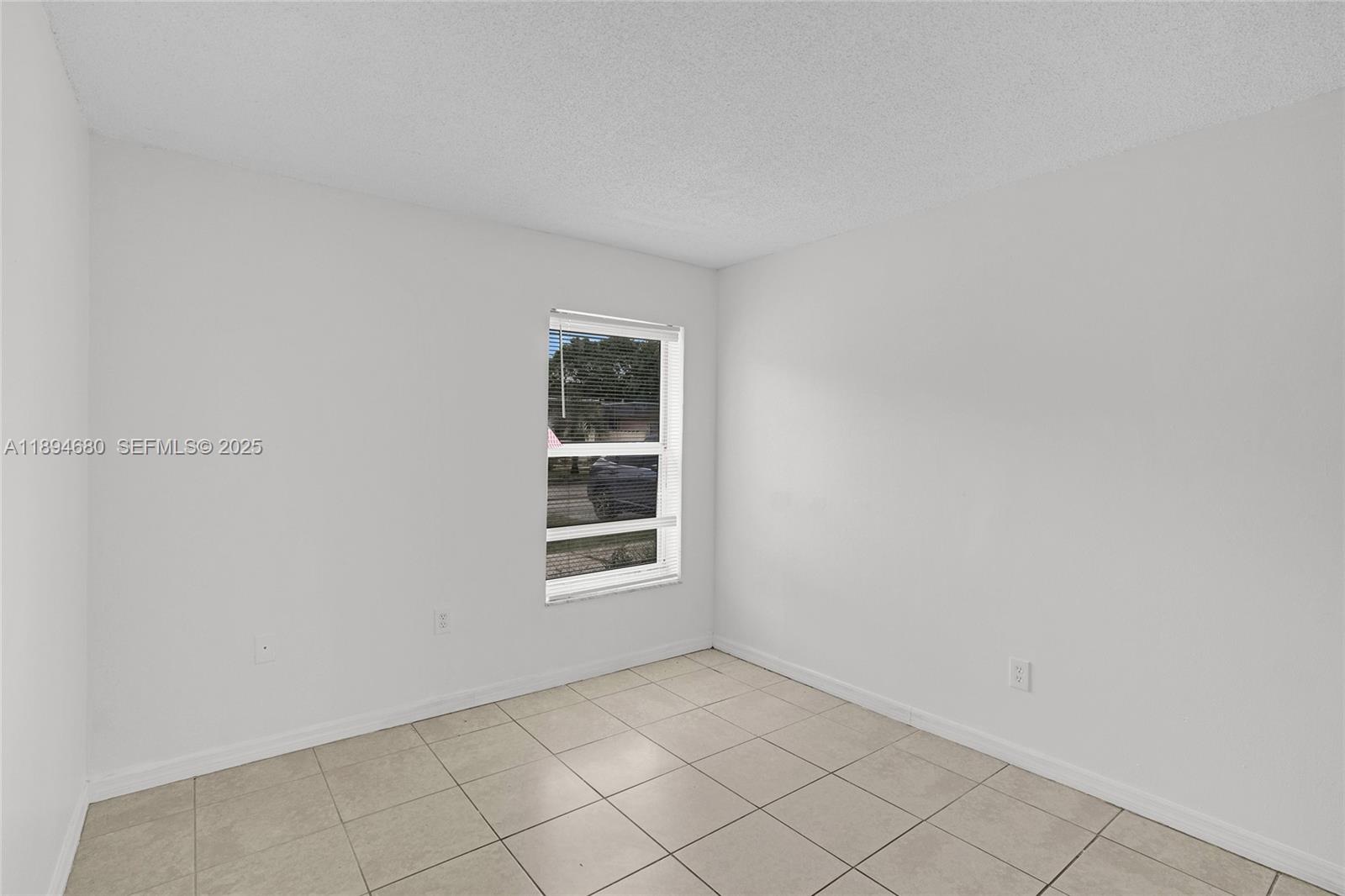 3876 Northwest 207 St Road Miami Gardens, FL 33055 - Photo 25 of 37 an empty room with windows