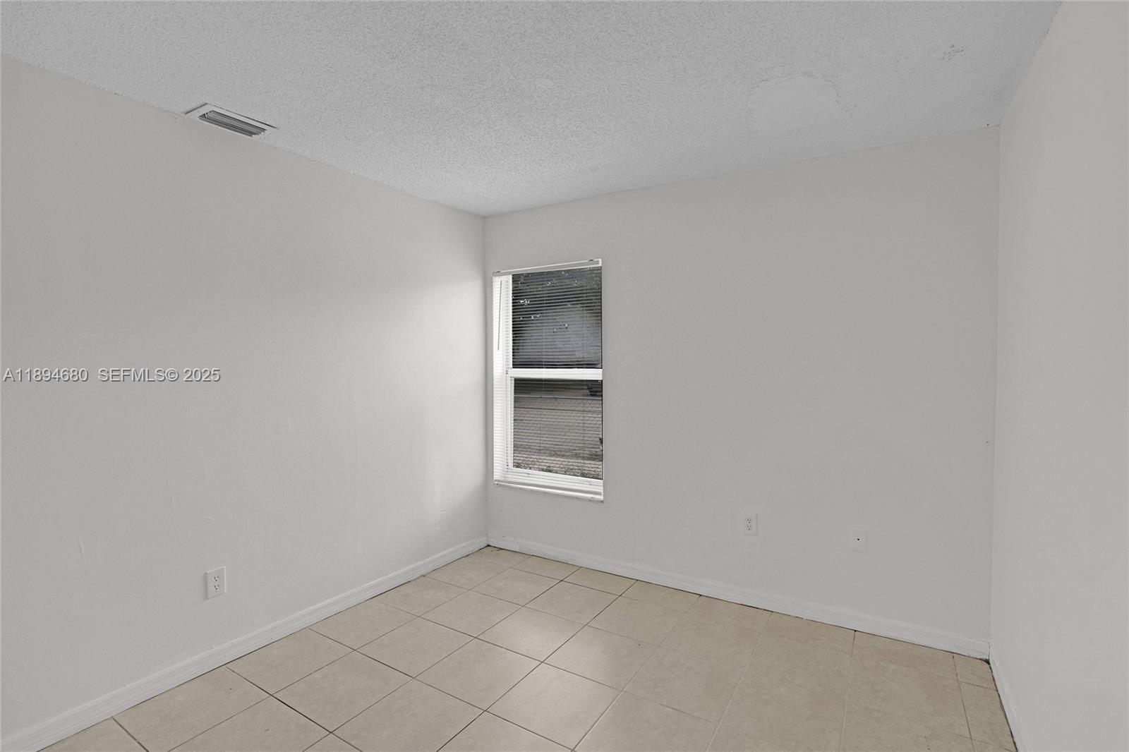 3876 Northwest 207 St Road Miami Gardens, FL 33055 - Photo 29 of 37 a view of an empty room with a window