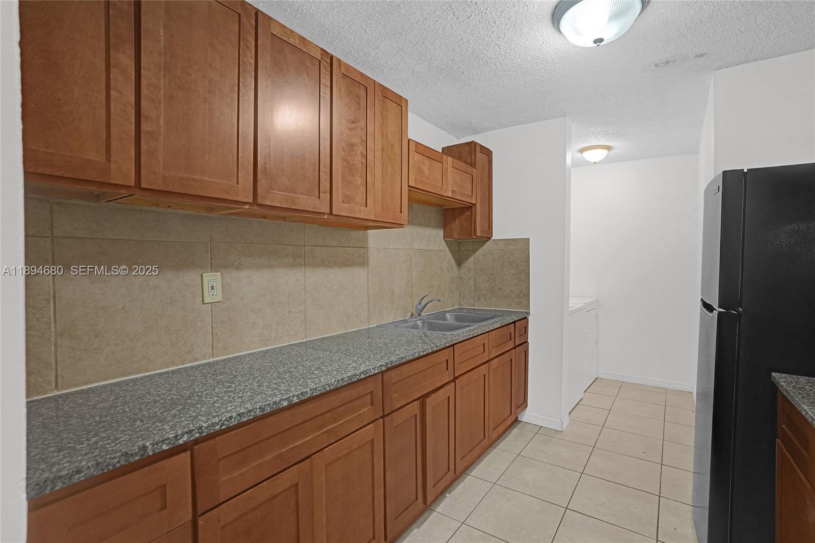 3876 Northwest 207 St Road Miami Gardens, FL 33055 - Photo 3 of 37 a kitchen with stainless steel appliances granite countertop a refrigerator and a sink