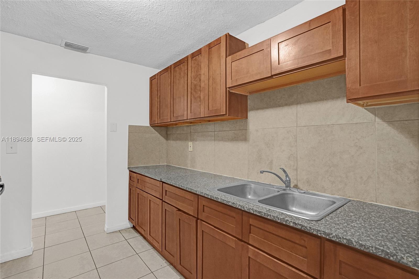 3876 Northwest 207 St Road Miami Gardens, FL 33055 - Photo 6 of 37 a kitchen with stainless steel appliances granite countertop a sink and cabinets