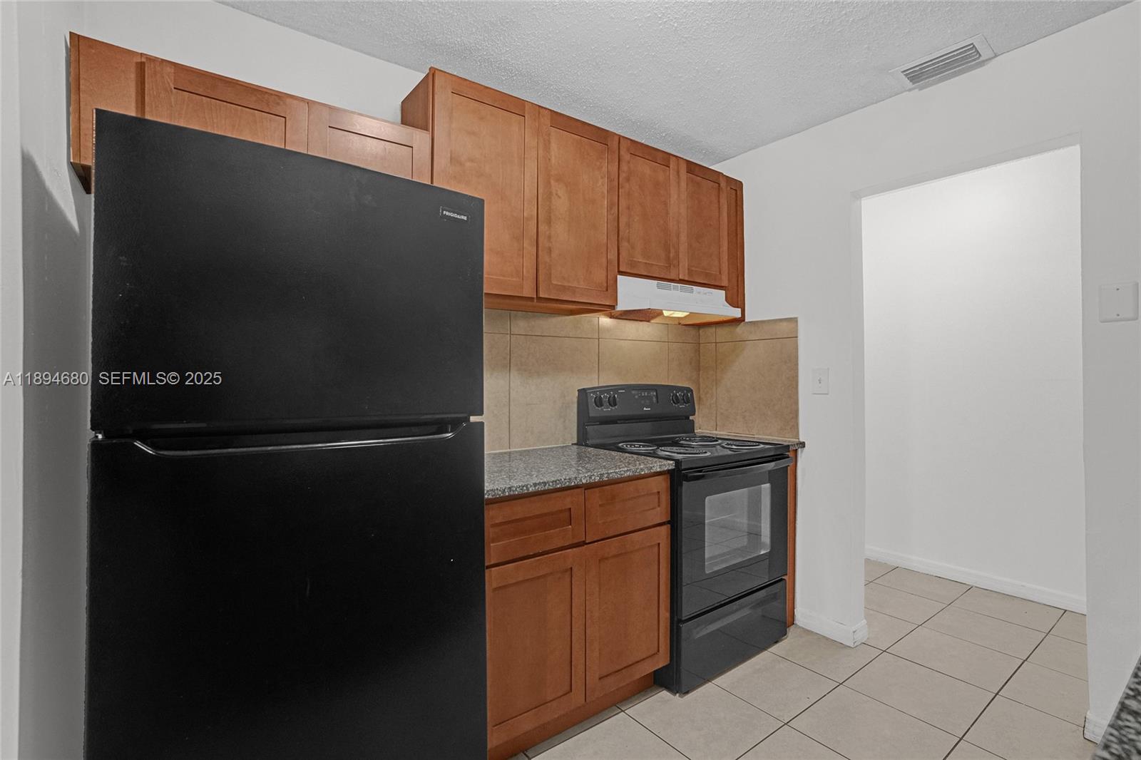 3876 Northwest 207 St Road Miami Gardens, FL 33055 - Photo 7 of 37 a kitchen with stainless steel appliances granite countertop a refrigerator and a stove top oven