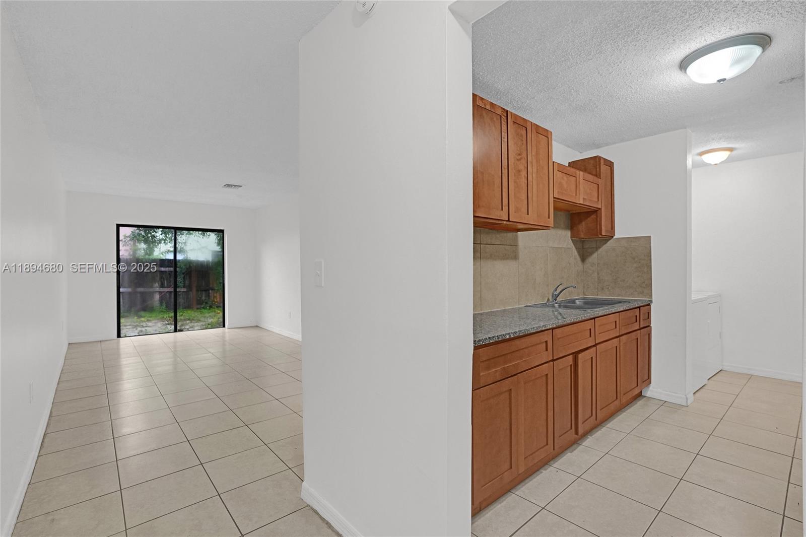 3876 Northwest 207 St Road Miami Gardens, FL 33055 - Photo 8 of 37 a room with a sink and a mirror