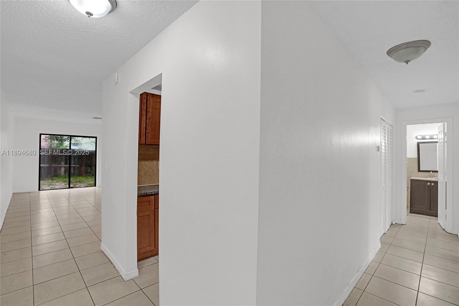 3876 Northwest 207 St Road Miami Gardens, FL 33055 - Photo 9 of 37 a view of hallway with natural light