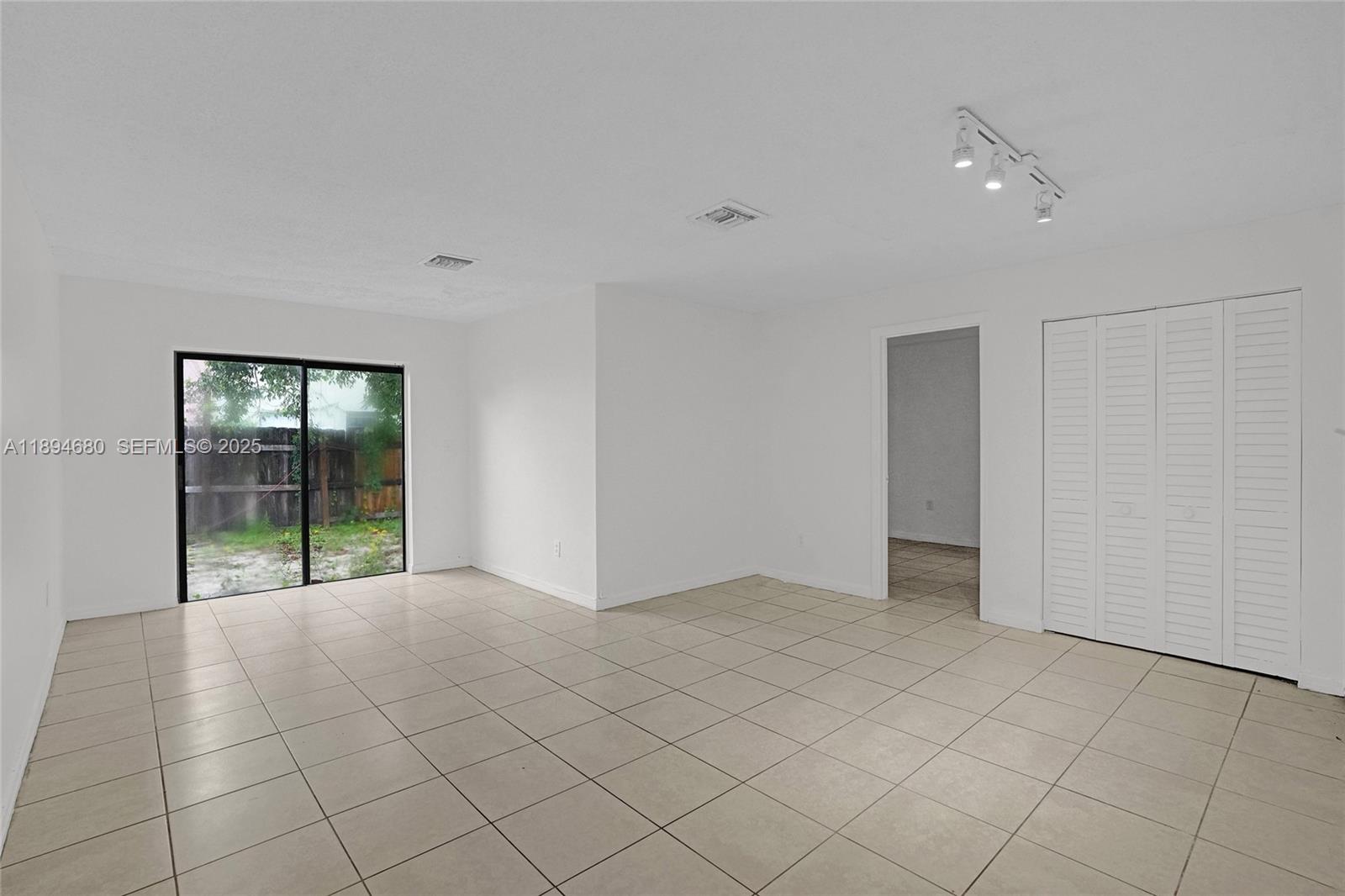 3876 Northwest 207 St Road Miami Gardens, FL 33055 - Photo 10 of 37 a view of an empty room with window
