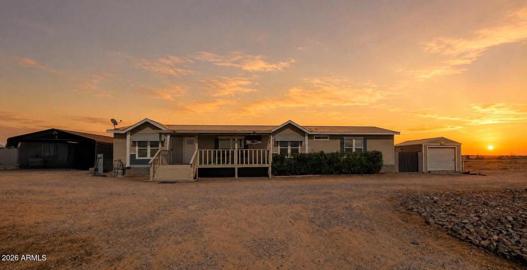 22417 West Dove Valley Road Wittmann, AZ 85361 - Photo 2 of 53 a view of a house with a yard and fence