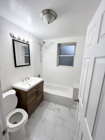 a bathroom with a sink toilet and a mirror