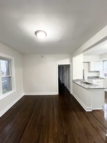 a view of a kitchen with wooden floor and a sink