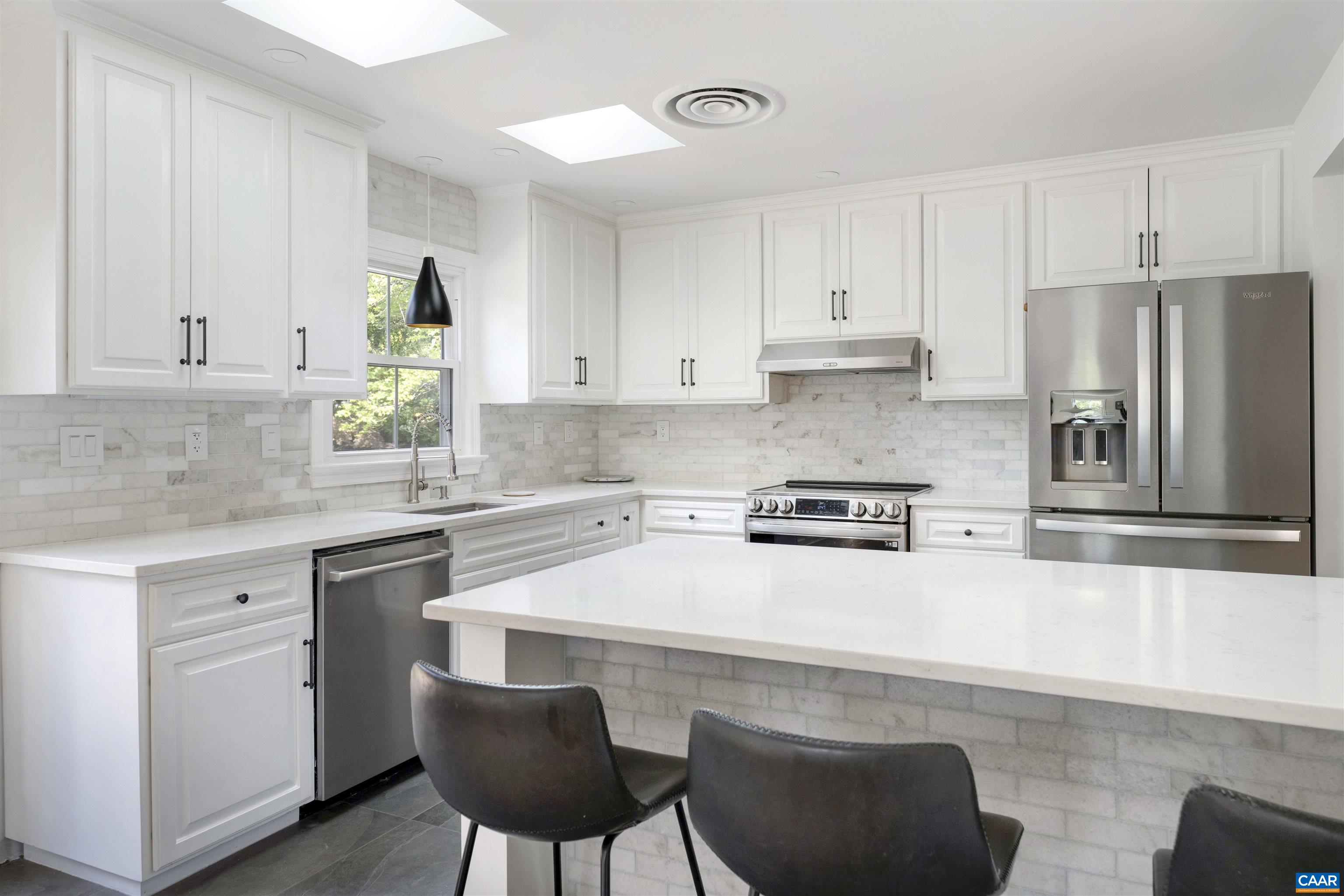 205 Chaucer Road Charlottesville, VA 22901 - Photo 12 of 43 a kitchen with stainless steel appliances a stove a sink and white cabinets