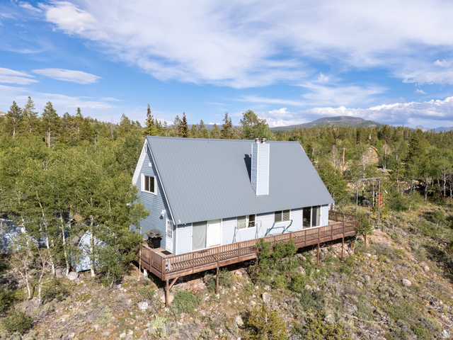 4770 Pine Crest Road Evanston, UT 82930 - Photo 15 of 24 A-frame style residence with light blue siding and a gray metal roof
