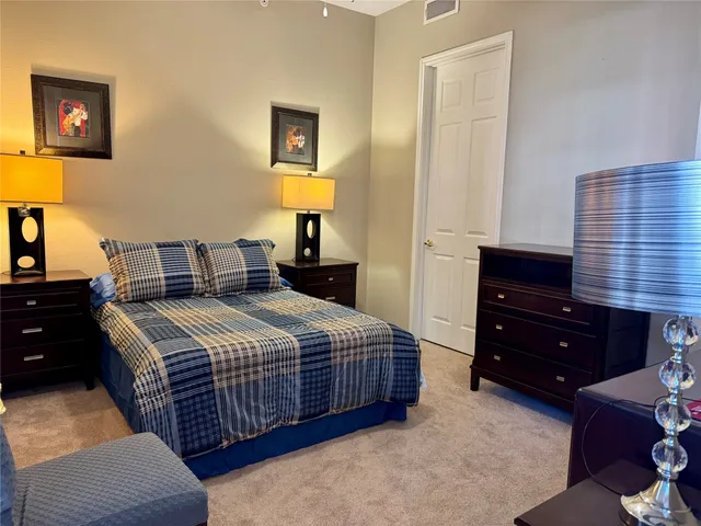 a bedroom with a bed and a night stand