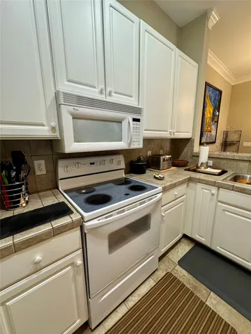 a kitchen with cabinets appliances and a counter space
