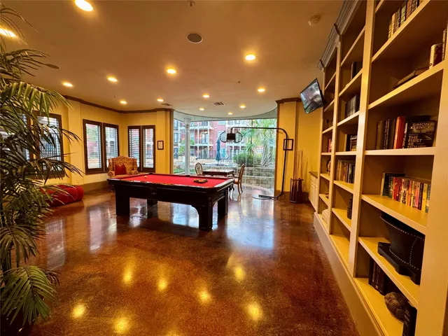 a room with furniture and pool table