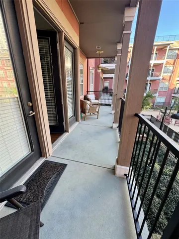 a view of a hallway with furniture and a window