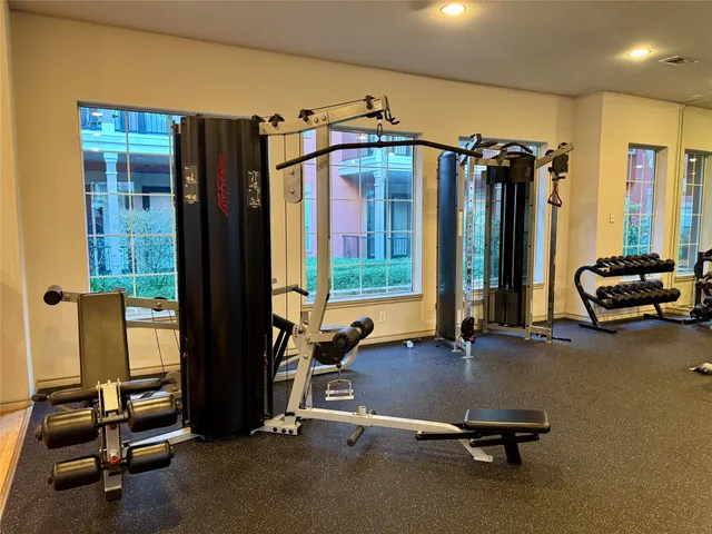 a room with gym equipment and a large window