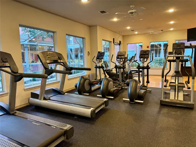 a view of a swimming pool with two chairs in a patio