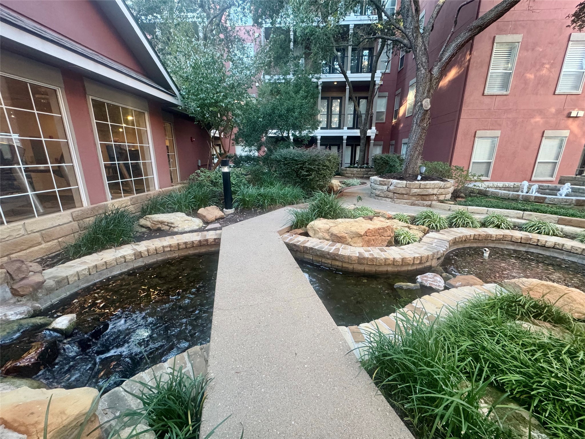 2400 McCue Road, Unit 233 Houston, TX 77056 - Photo 37 of 41 a view of a swimming pool with two chairs in a patio