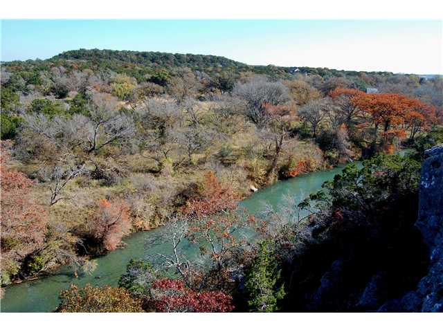 4030 Fischer Store Road Wimberley, TX 78676 - Photo 1 of 1 a view of a lush green field with lots of bushes