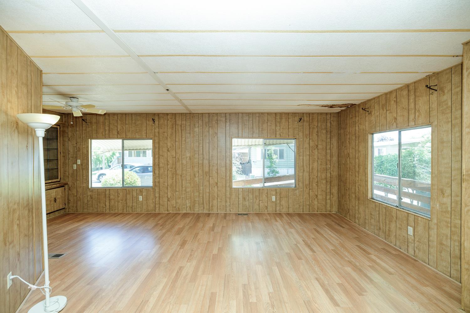 2621 Prescott Road, Unit 158 Modesto, CA 95350 - Photo 14 of 35 a view of empty room with wooden floor and fan