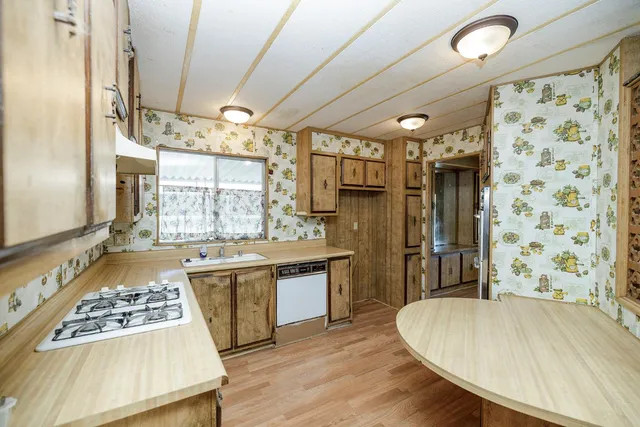 a kitchen with a sink a stove and a refrigerator